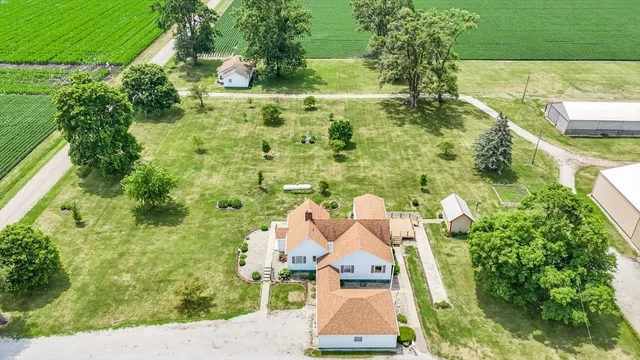an aerial view of a house with a yard