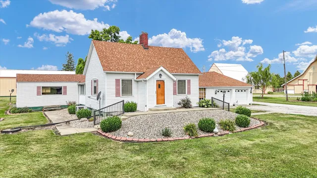 a view of a house with backyard and sitting area