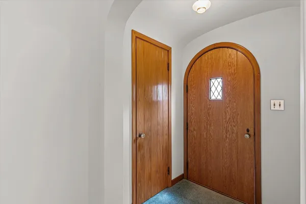 an empty room with fireplace and window