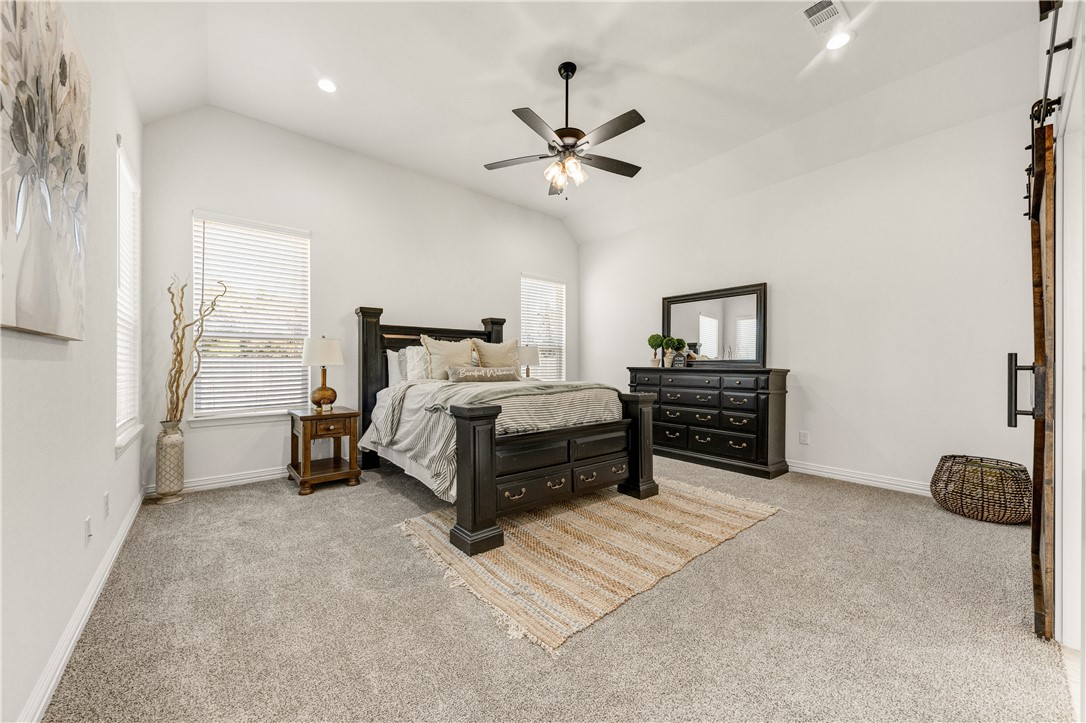 1624 Bennett Street Bryan, TX 77802 - Photo 14 of 22 a spacious bedroom with a bed and a ceiling fan