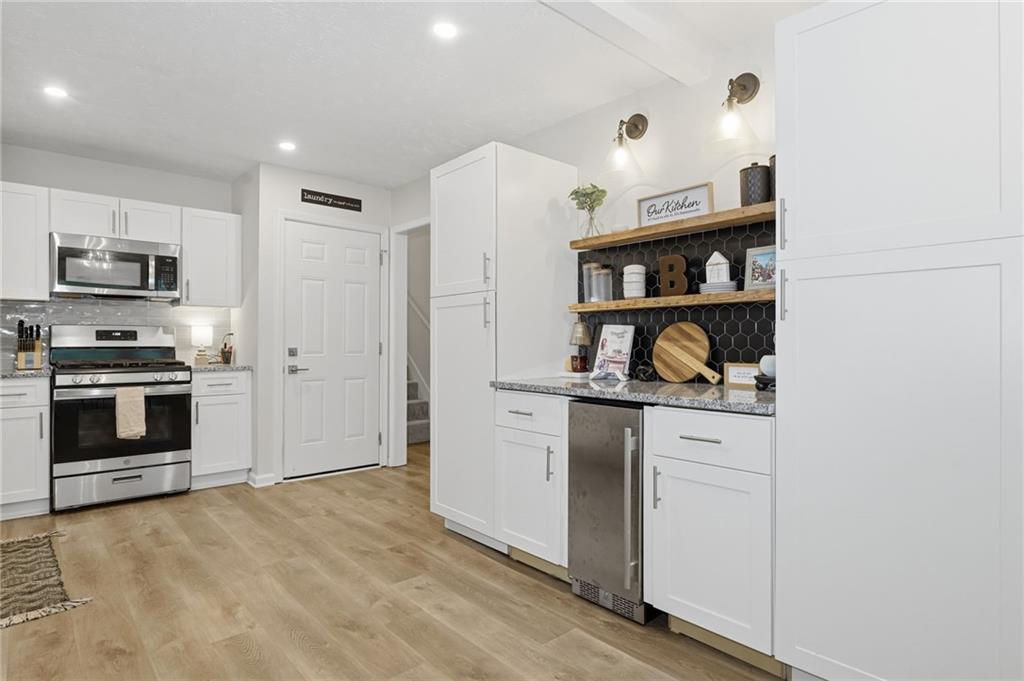 404 Brooks Street Dallas, GA 30157 - Photo 9 of 38 a kitchen with stainless steel appliances granite countertop a stove and a refrigerator