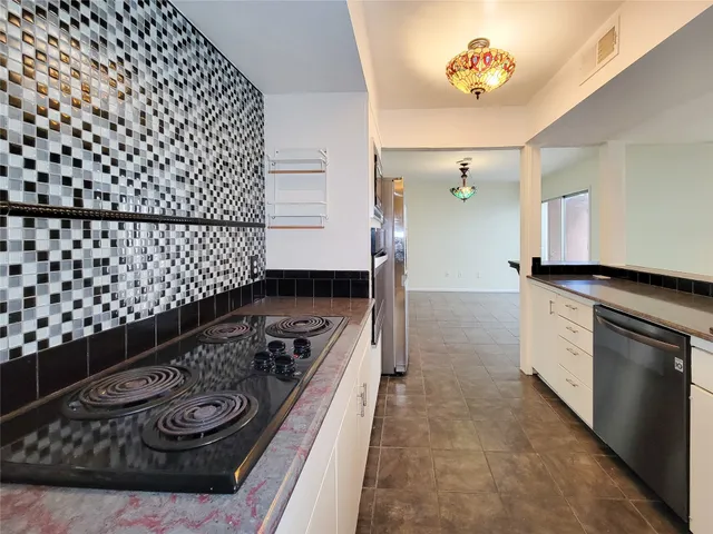 a kitchen with a stove and cabinets