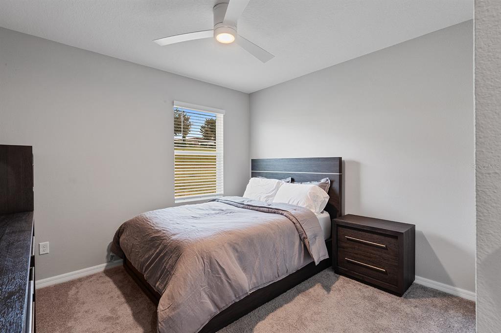 1328 Calmito Lane Mount Dora, FL 32757 - Photo 11 of 29 a bedroom with a bed and a chandelier