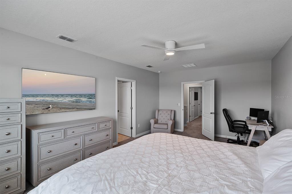 1328 Calmito Lane Mount Dora, FL 32757 - Photo 16 of 29 a bedroom with a bed and a chandelier