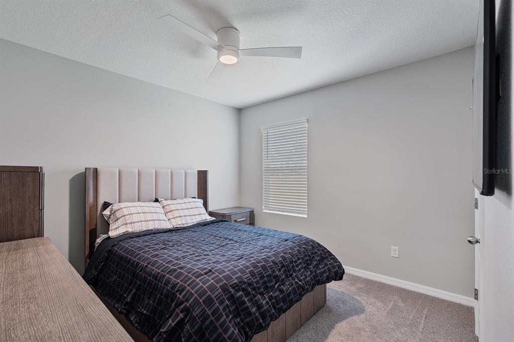 1328 Calmito Lane Mount Dora, FL 32757 - Photo 22 of 29 a bedroom with a bed and a window