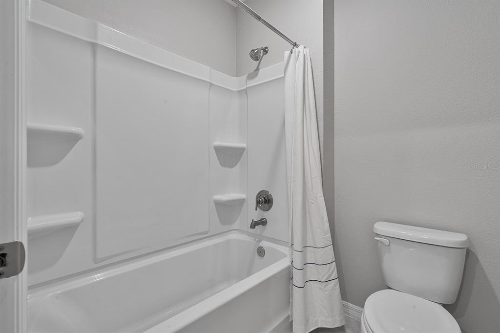1328 Calmito Lane Mount Dora, FL 32757 - Photo 23 of 29 a bathroom with a toilet and a bathtub