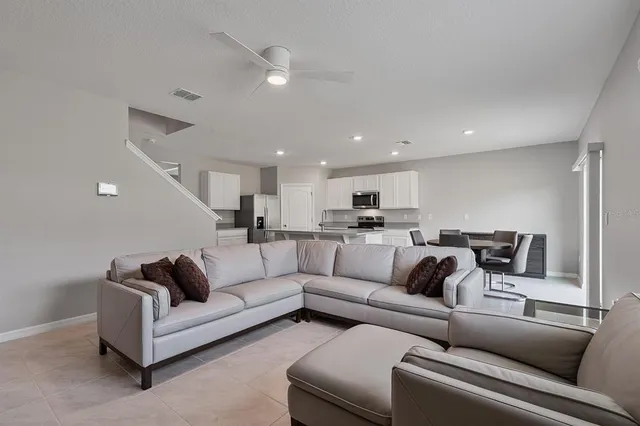 a living room with furniture white walls and a couch
