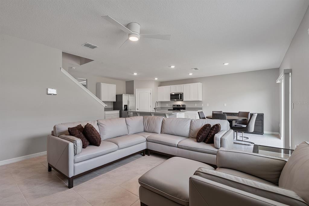 1328 Calmito Lane Mount Dora, FL 32757 - Photo 6 of 29 a living room with furniture white walls and a couch