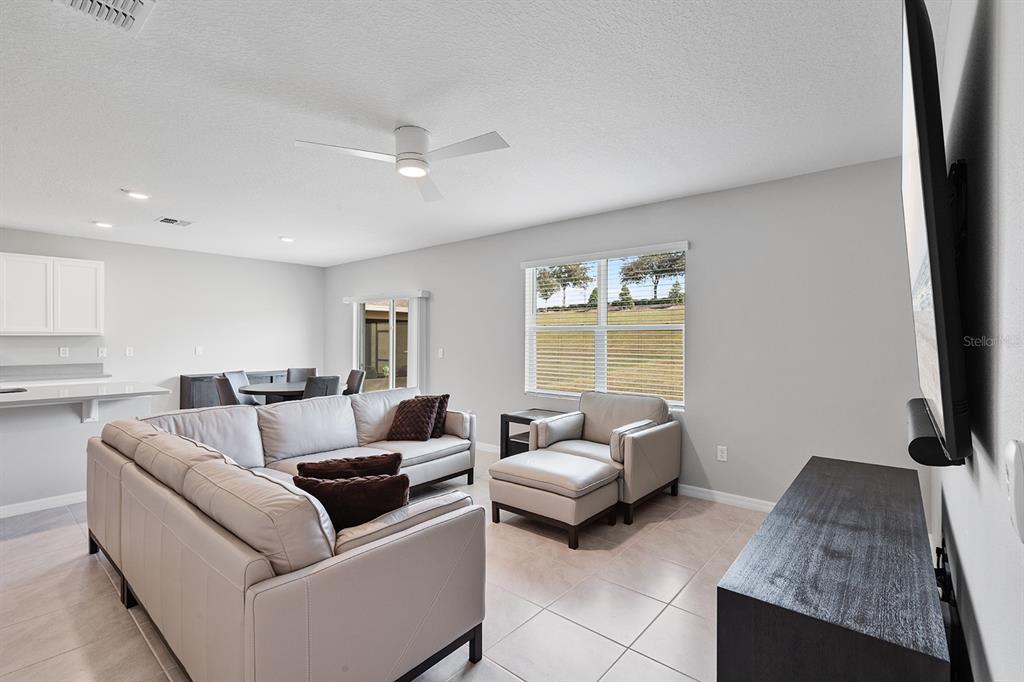 1328 Calmito Lane Mount Dora, FL 32757 - Photo 8 of 29 a living room with furniture and a flat screen tv