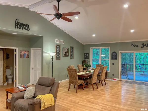 a view of a dining room with furniture and chandelier