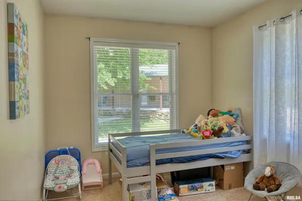 an aerial view of green landscape with trees houses and lake view