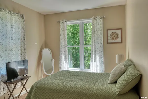 an aerial view of residential house with outdoor space and trees all around