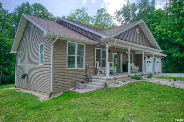 a backyard of a house with plants and outdoor seating