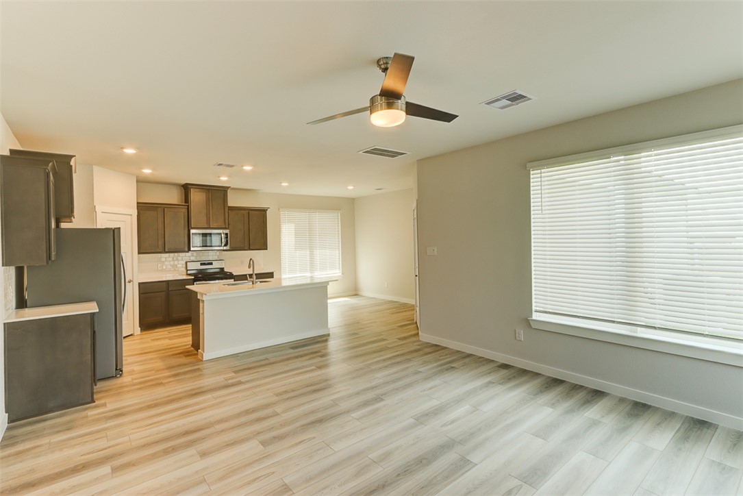 760 Double Mountain Road College Station, TX 77845 - Photo 4 of 26 a view of kitchen with kitchen island wooden floor center island and appliances