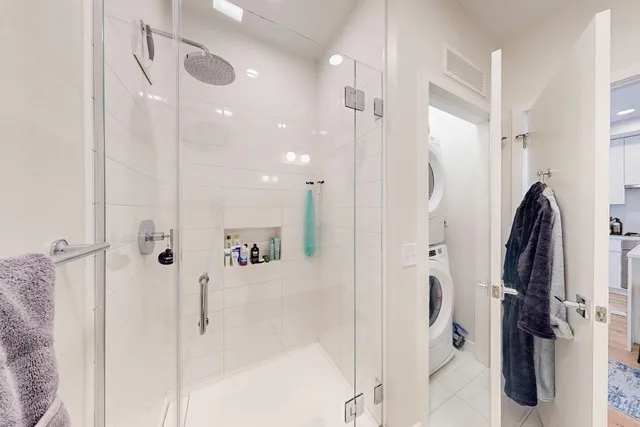 a bathroom with a shower and a glass door