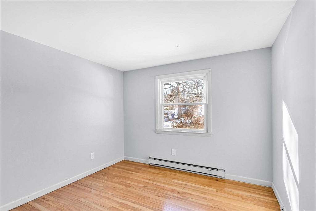 232 Spikenard Circle Springfield, MA 01129 - Photo 12 of 42 an empty room with wooden floor and windows