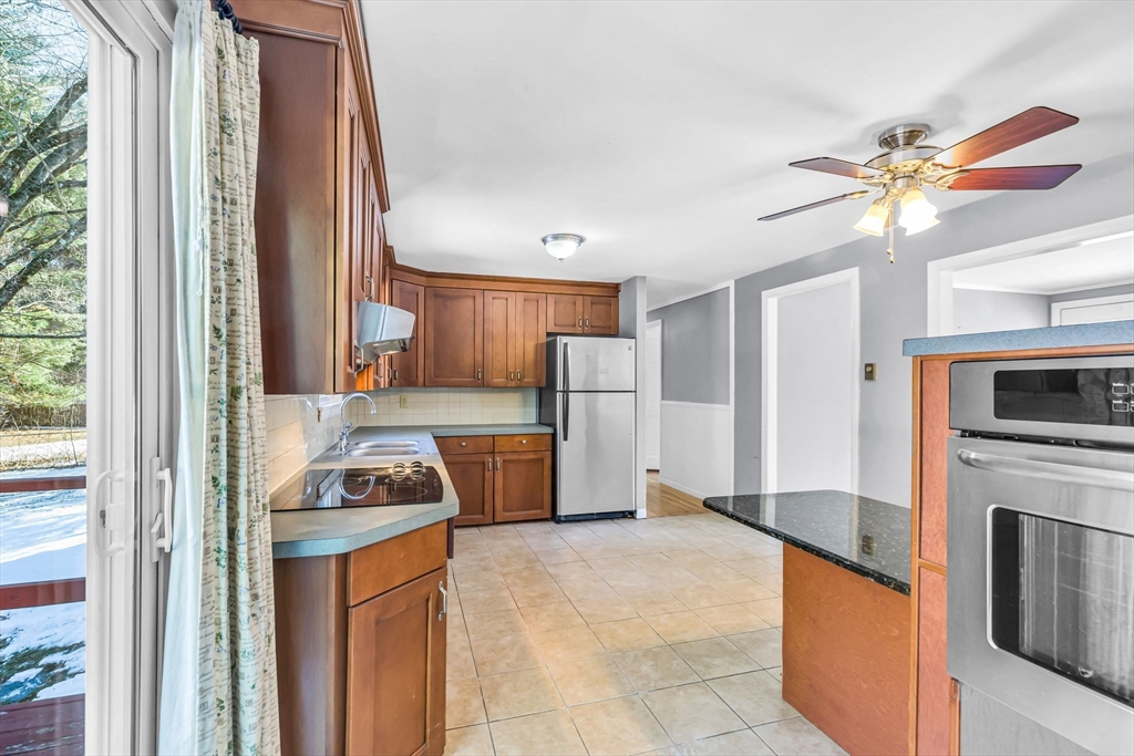 232 Spikenard Circle Springfield, MA 01129 - Photo 6 of 42 a kitchen with stainless steel appliances granite countertop a refrigerator a stove and a sink with wooden floor