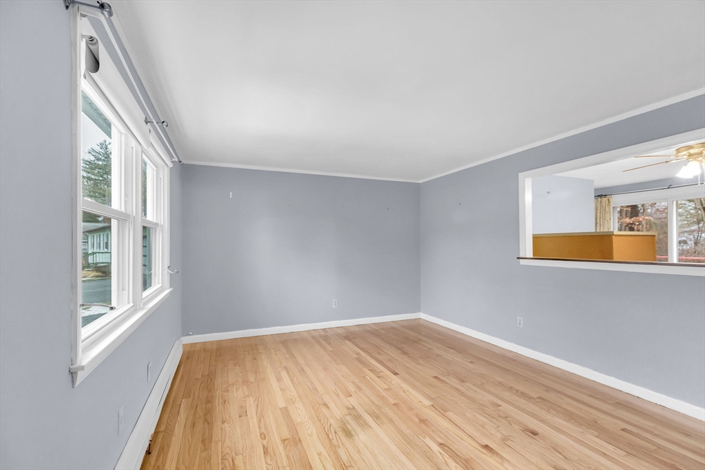 232 Spikenard Circle Springfield, MA 01129 - Photo 8 of 42 a view of empty room with wooden floor and fan