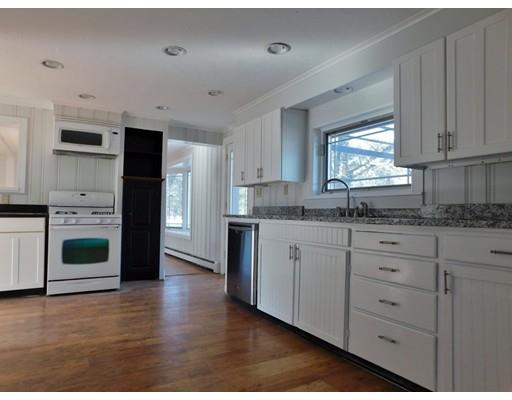 63 Hayden Pond Road Dudley, MA 01571 - Photo 2 of 22 a kitchen with granite countertop white cabinets and white appliances