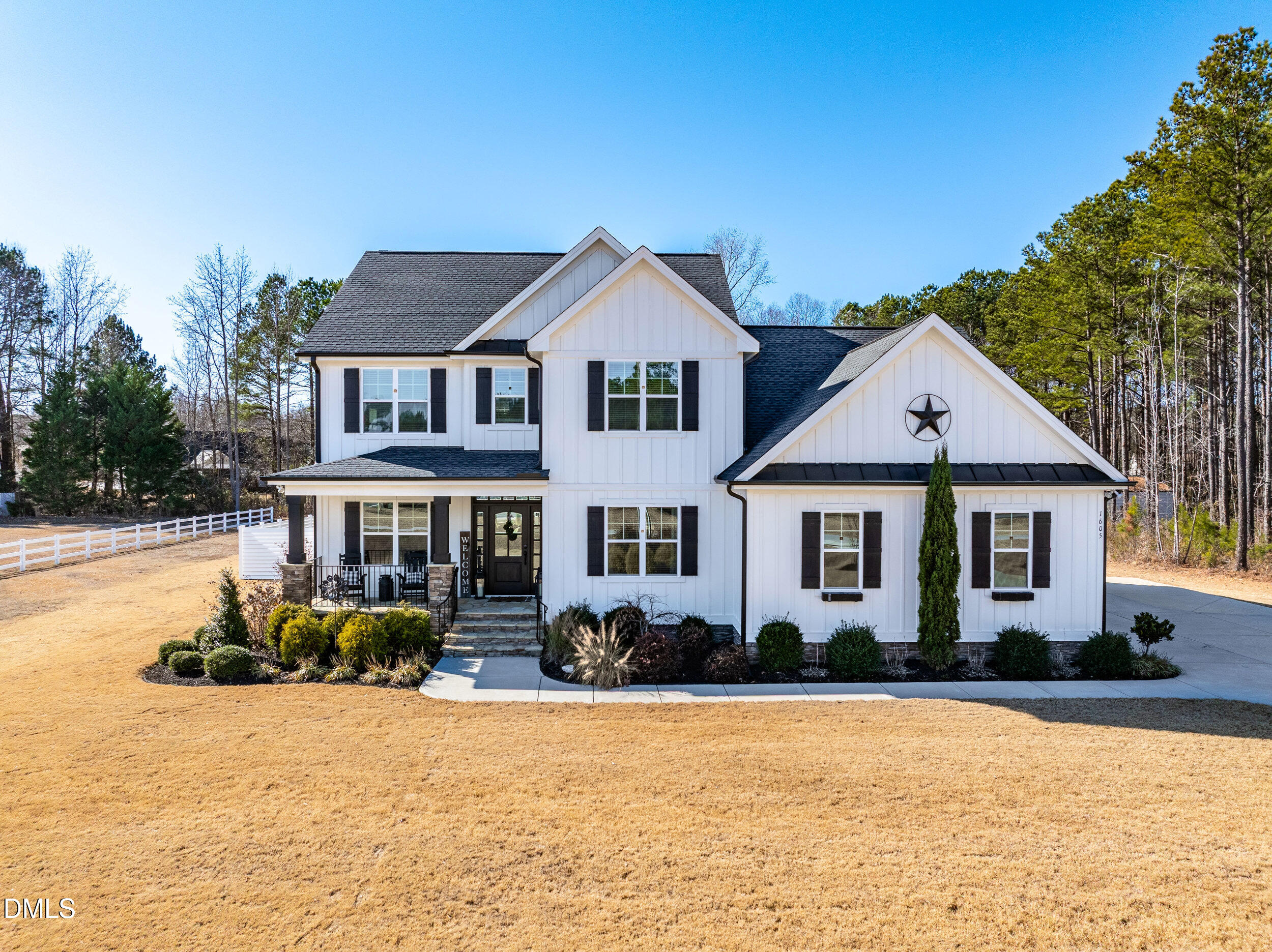 a front view of a house with yard and green space