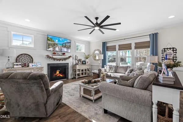 a living room with furniture a fireplace and a window