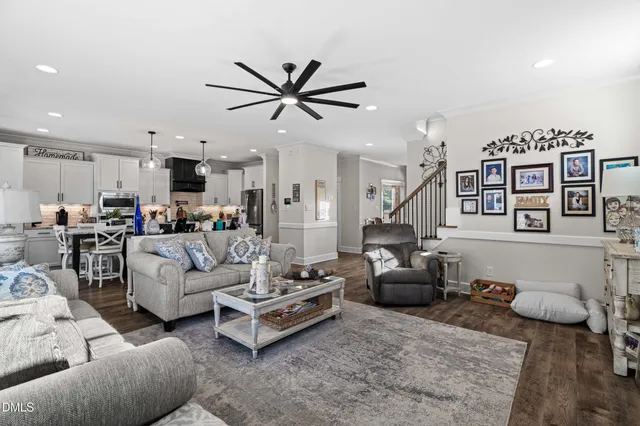 a living room with furniture and kitchen view