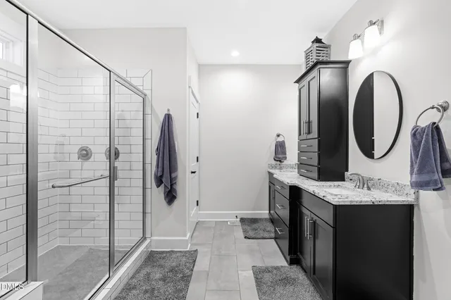 a bathroom with a sink double vanity and a mirror