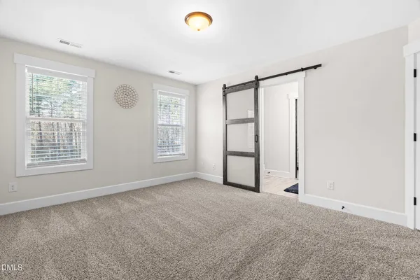 a spacious bedroom with a bed and window