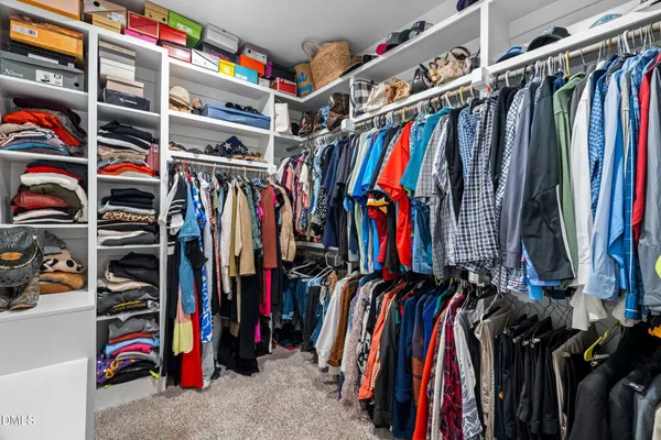 a view of a patio with table and chairs potted plants and a large tree