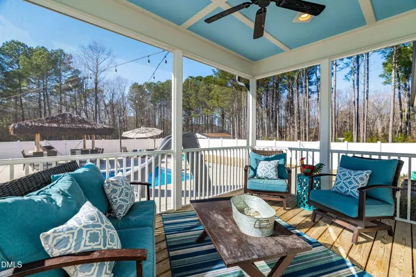 a view of living room kitchen with stainless steel appliances granite countertop couches and wooden cabinets