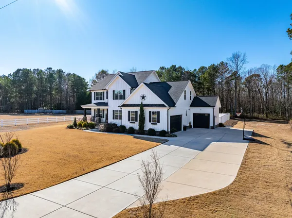 a view of a house with a yard and sitting area