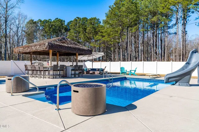 a view of backyard with outdoor seating and trees