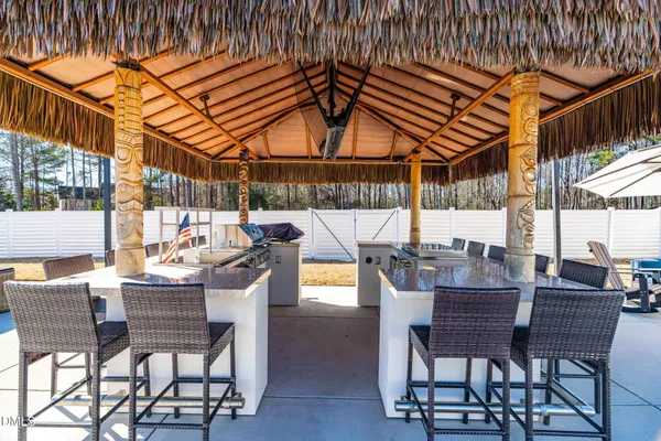 a view of a house with backyard and sitting area