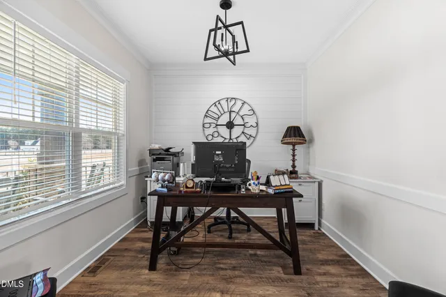 a view of a workspace room with furniture window and wooden floor