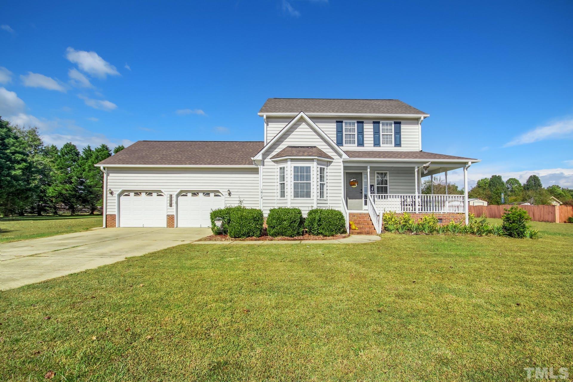 1013 Holland Ridge Drive Raleigh, NC 27603 - Photo 1 of 29 a front view of a house with a garden and yard