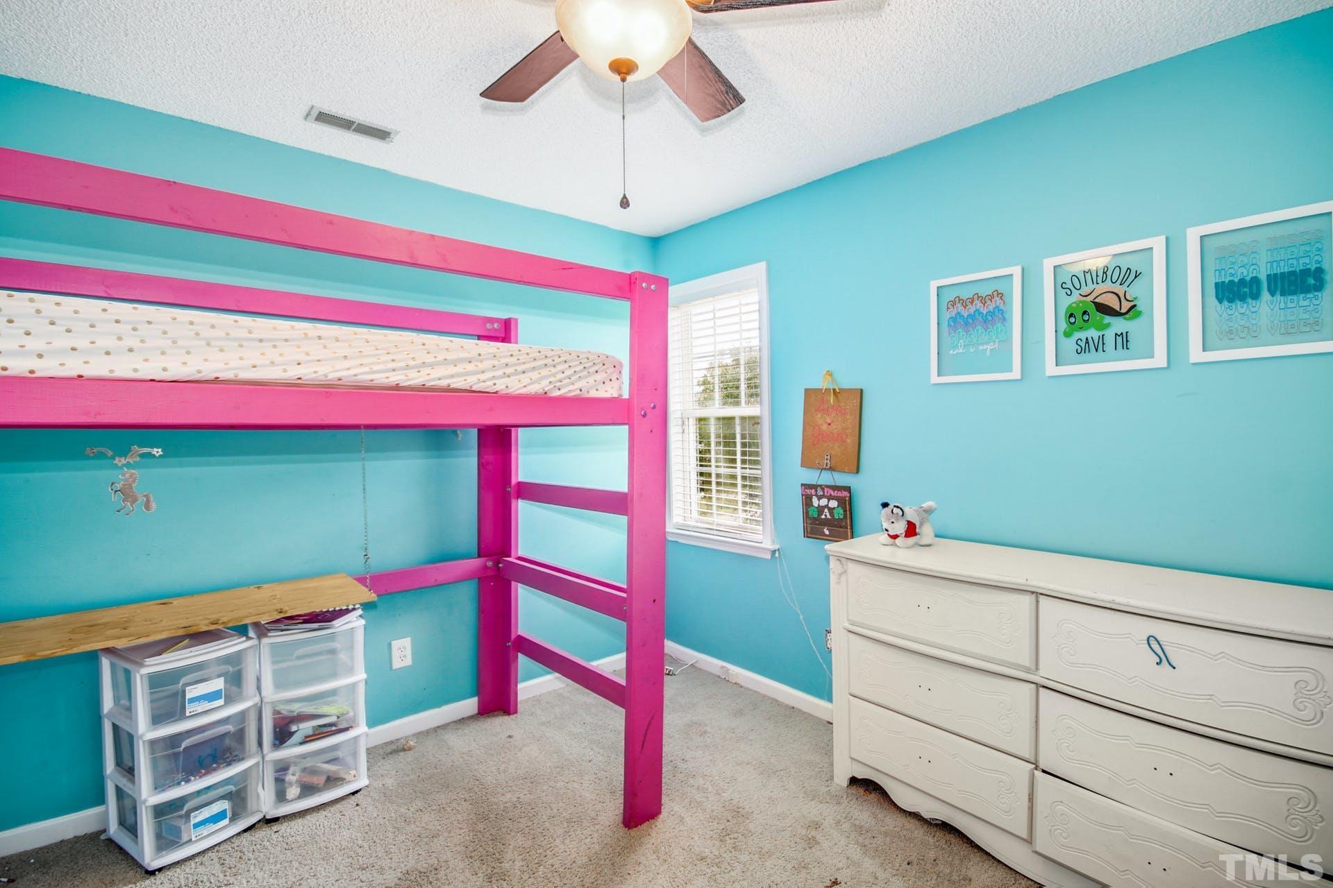 1013 Holland Ridge Drive Raleigh, NC 27603 - Photo 19 of 29 a bedroom with a bed and a dresser