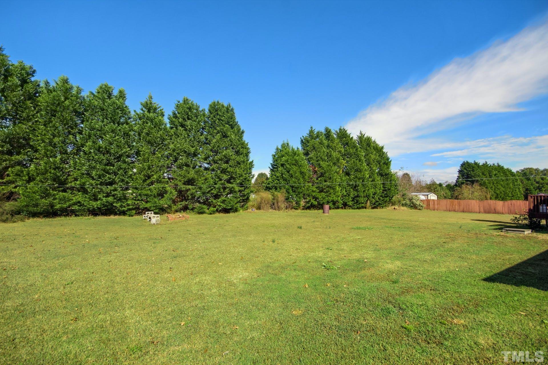 1013 Holland Ridge Drive Raleigh, NC 27603 - Photo 23 of 29 a view of yard with swimming pool and green space