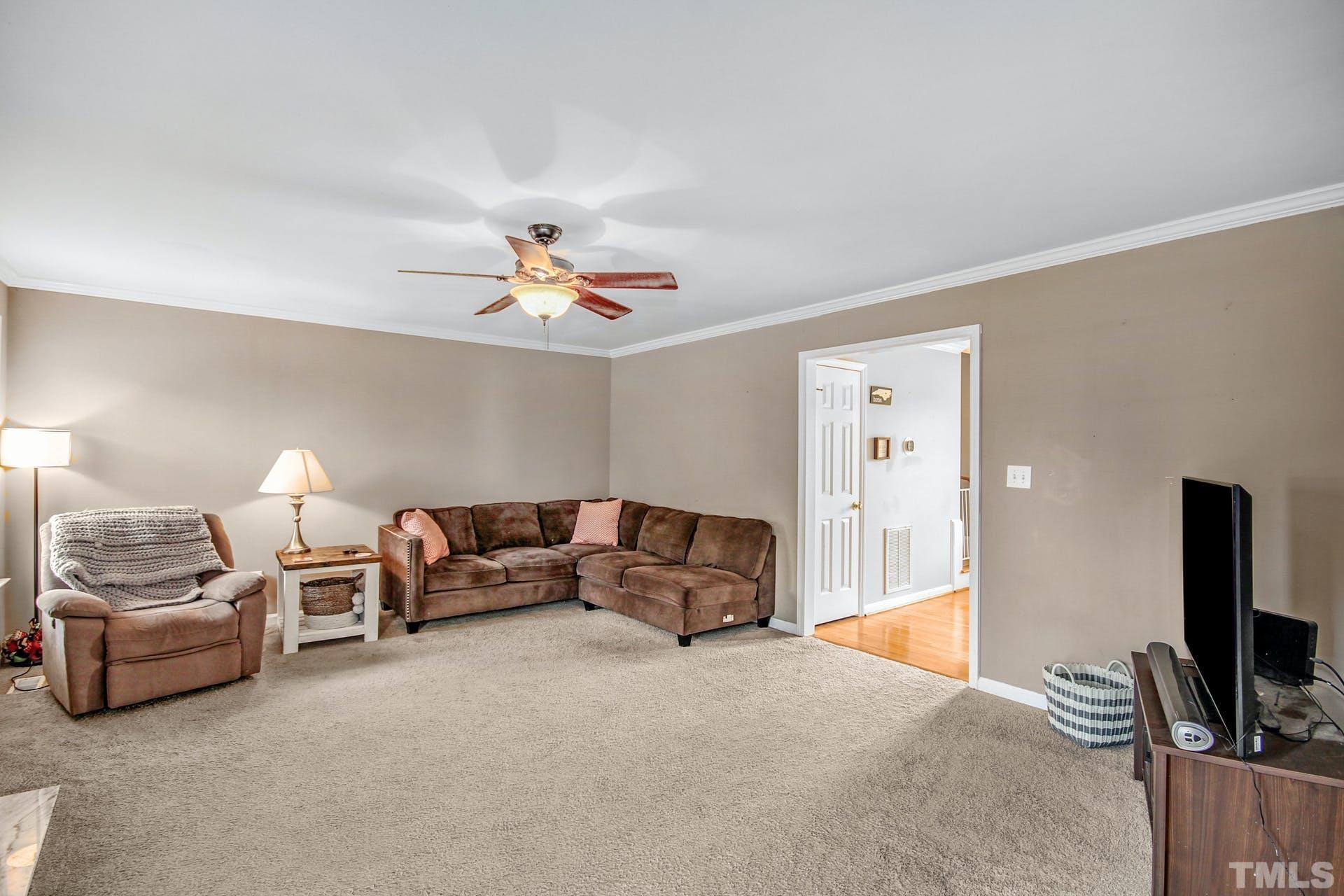 1013 Holland Ridge Drive Raleigh, NC 27603 - Photo 4 of 29 a bed room with furniture and a flat screen tv