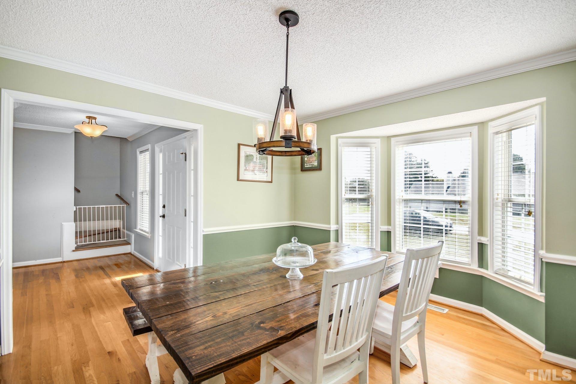 1013 Holland Ridge Drive Raleigh, NC 27603 - Photo 5 of 29 a view of a dining room with furniture window and wooden floor