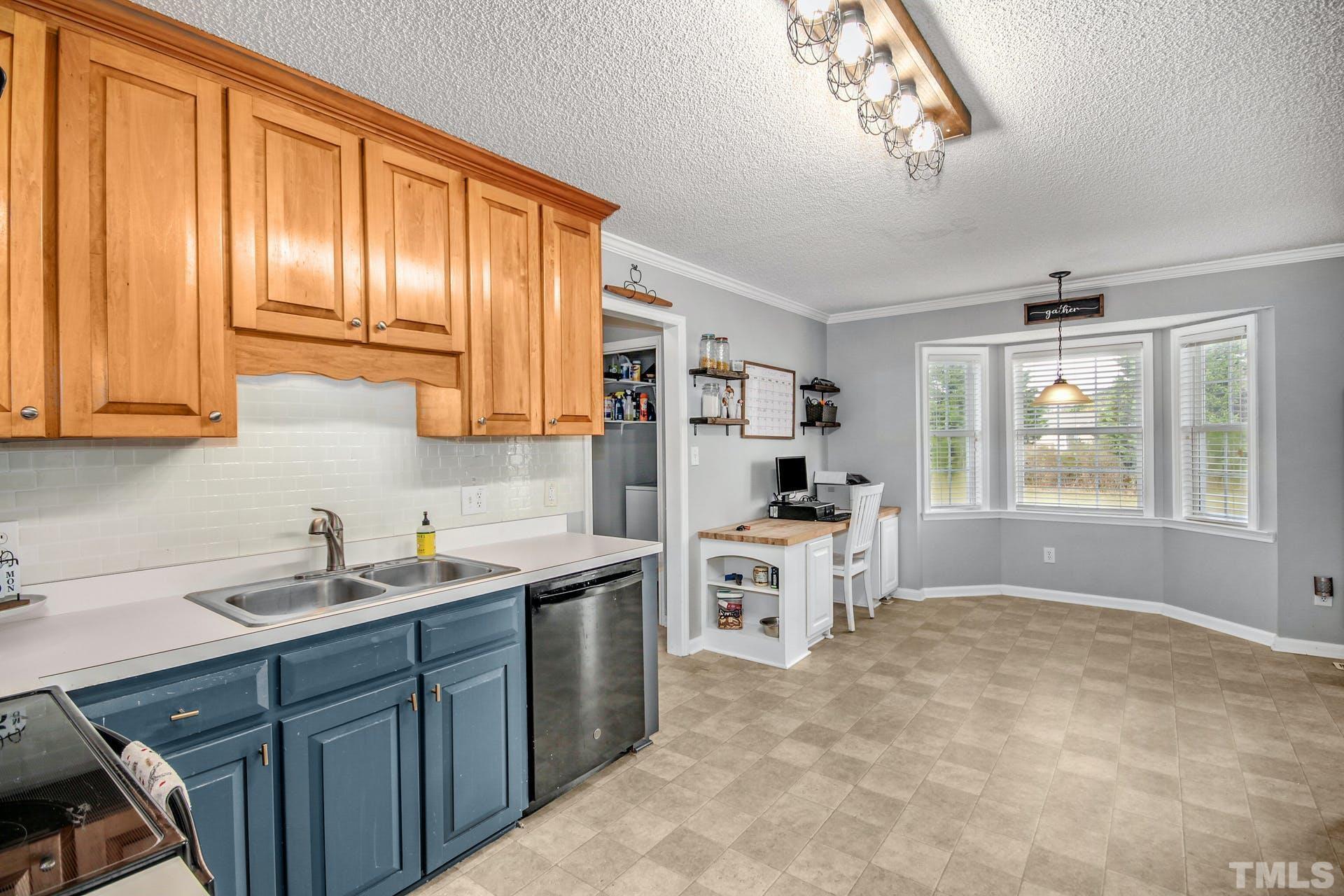 1013 Holland Ridge Drive Raleigh, NC 27603 - Photo 10 of 29 a kitchen with cabinets a sink and appliances