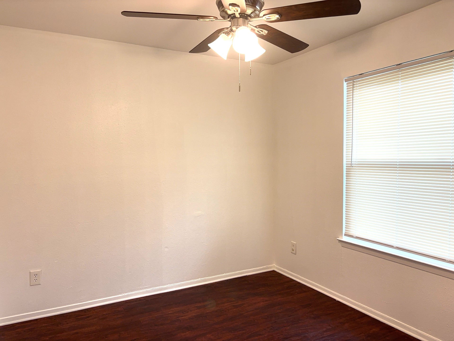 16005 Stoneham Circle Pflugerville, TX 78660 - Photo 14 of 18 Empty room featuring ceiling fan and dark wood finished floors