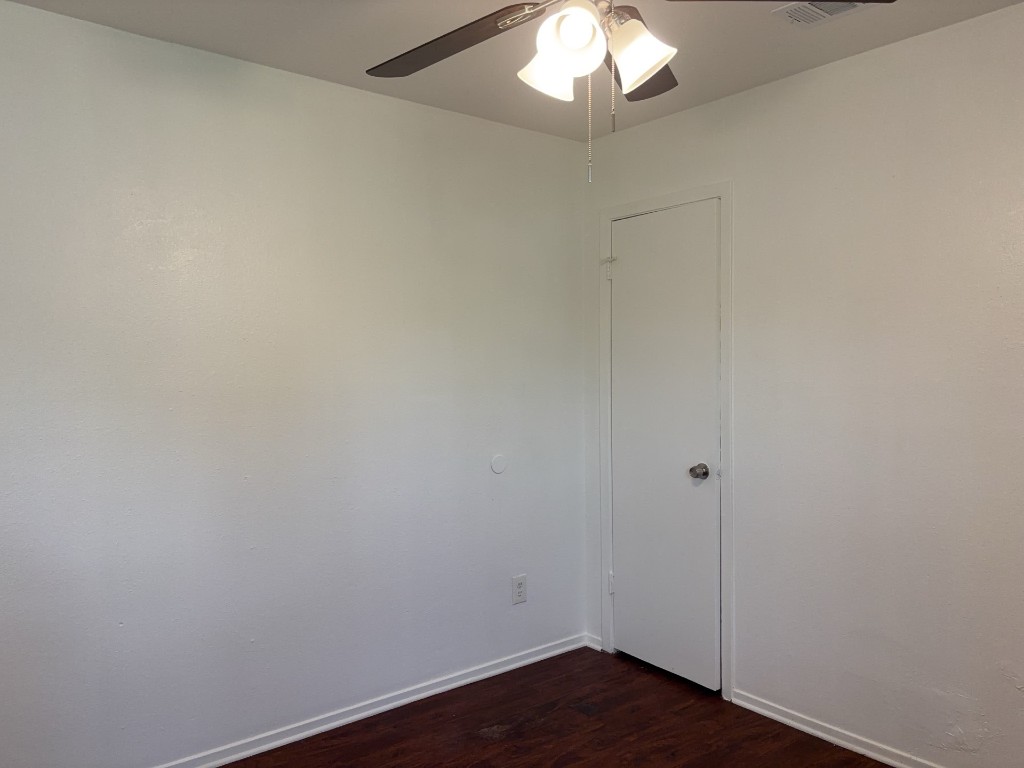 16005 Stoneham Circle Pflugerville, TX 78660 - Photo 17 of 18 a view of an empty room with wooden floor