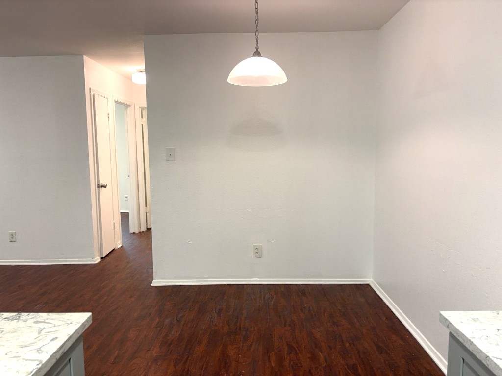 16005 Stoneham Circle Pflugerville, TX 78660 - Photo 6 of 18 a view of a room with wooden floor and a window