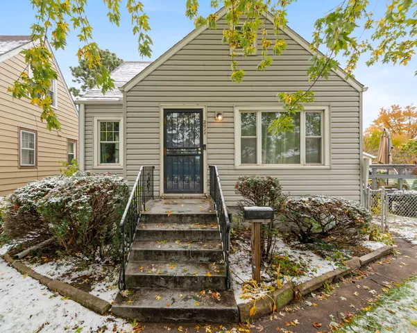 a front view of a house with outdoor seating