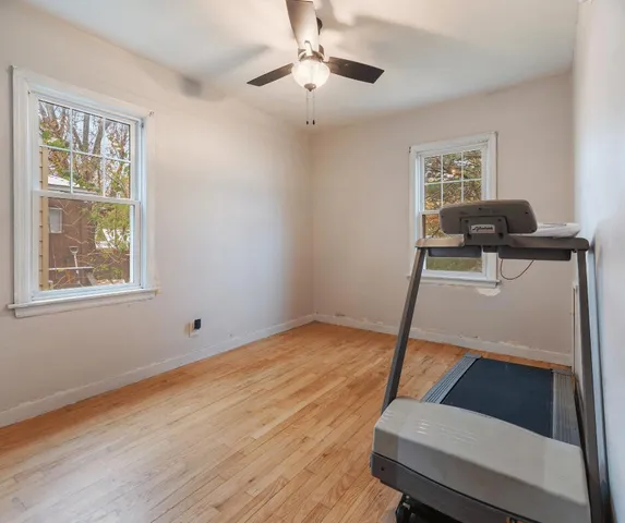 a view of room with window and wooden floor