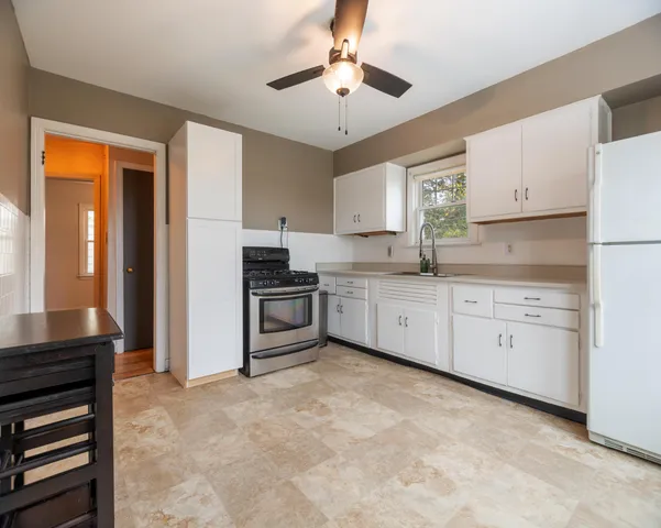 a kitchen with a sink stove and cabinets