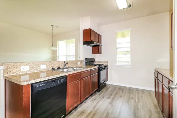 a kitchen with a sink stove and cabinets