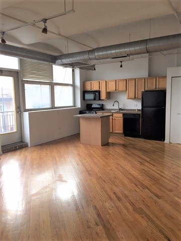 500 South Clinton Street, Unit 611 Chicago, IL 60607 - Photo 2 of 19 a kitchen with stainless steel appliances granite countertop a refrigerator and a stove