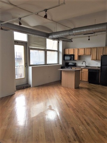 500 South Clinton Street, Unit 611 Chicago, IL 60607 - Photo 16 of 19 a kitchen with a wooden floor and a window