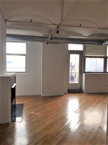500 South Clinton Street, Unit 611 Chicago, IL 60607 - Photo 3 of 19 a view of a livingroom with wooden floor and windows